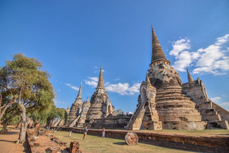 Multiple ancient pagodas and stupas of Ayutthaya Historical Park under a clear sky