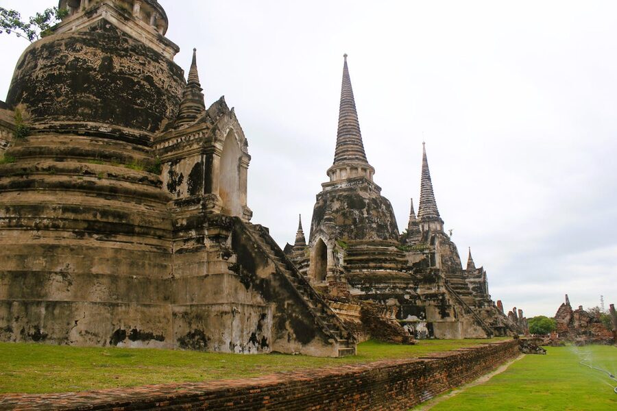 Close-up of ancient stone temple facade showing weathered brick and carved details in Ayutthaya