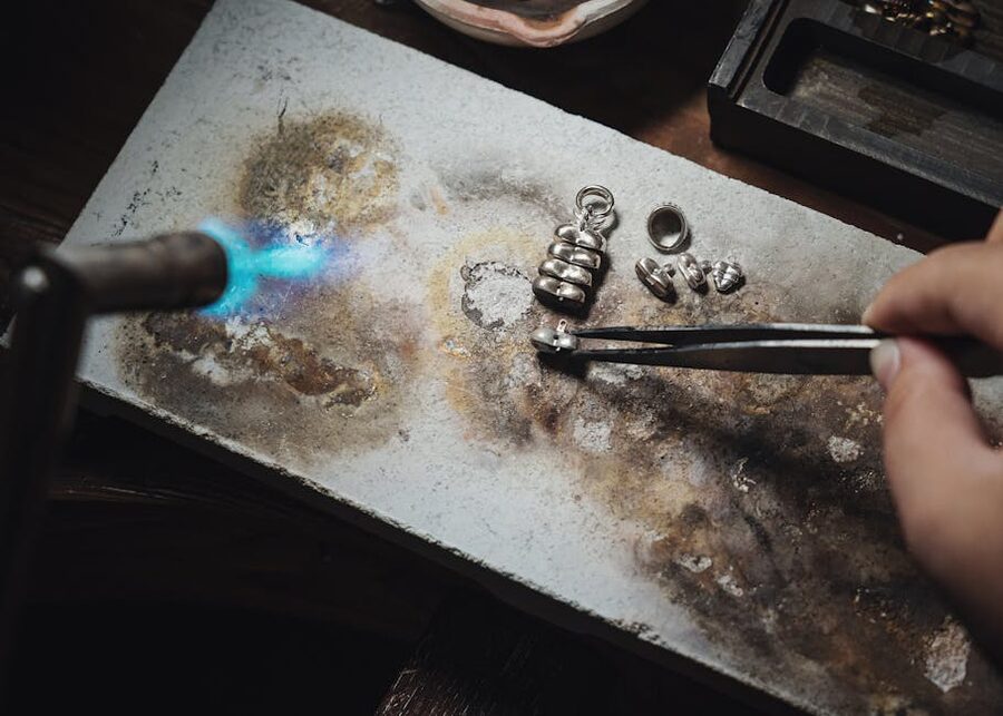 Artisan hands crafting silver jewelry