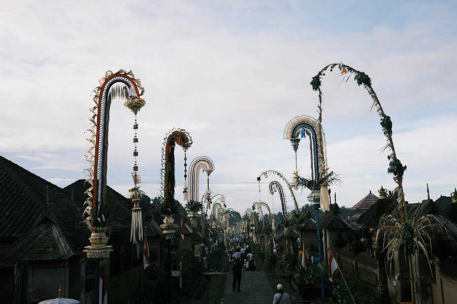 Decorative penjor poles along a Balinese street