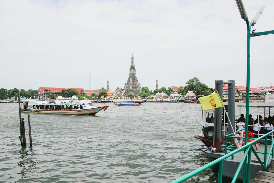 View along the Chao Phraya River in Bangkok with Wat Arun visible in the background