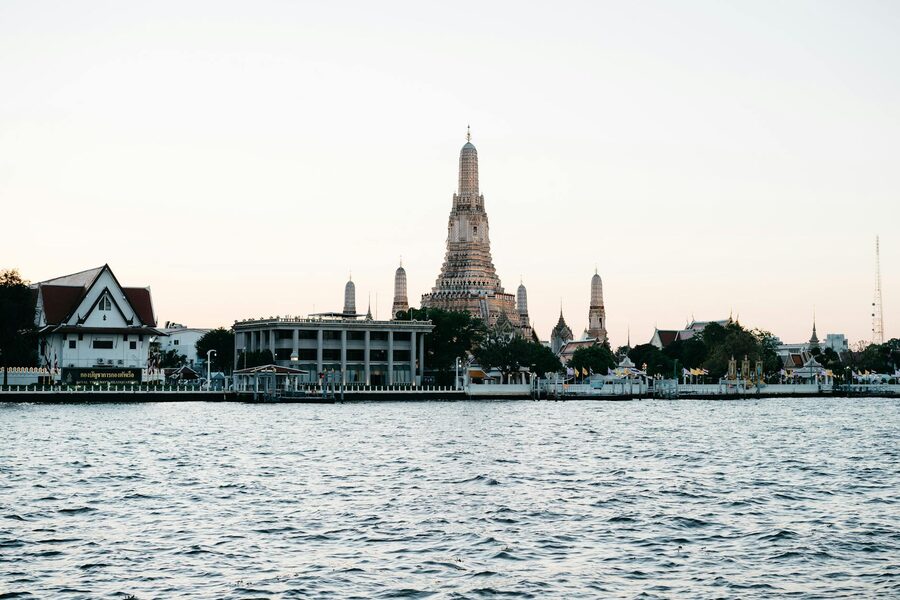 Wat Arun temple by the river during blue hour in Bangkok