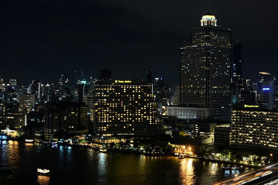 Bangkok waterfront skyscrapers and lights reflected in the Chao Phraya River at night