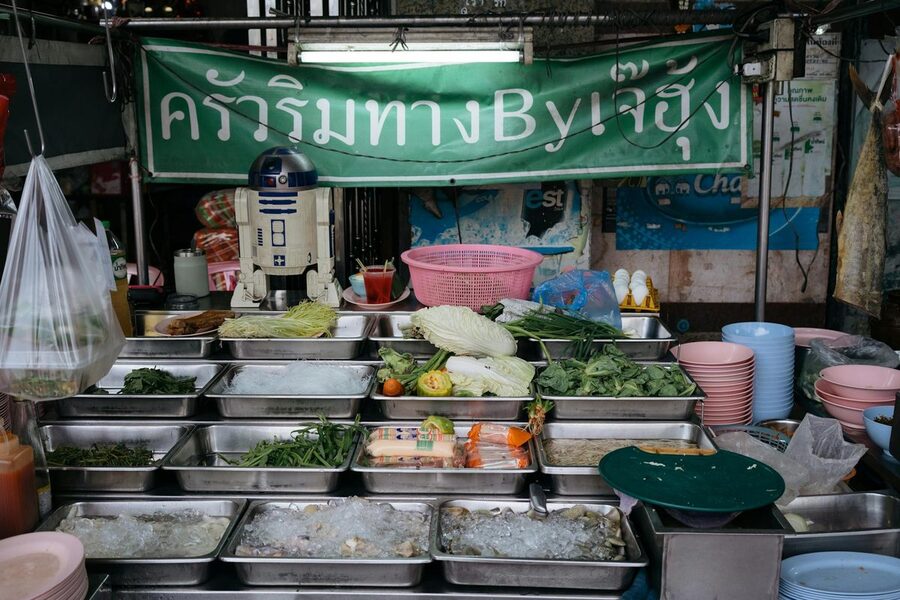 Colorful array of fresh ingredients displayed at Thai food stall in Bangkok