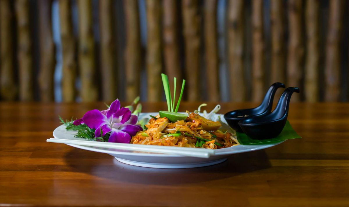 Close-up of traditional Thai Pad Thai noodle dish with garnishes