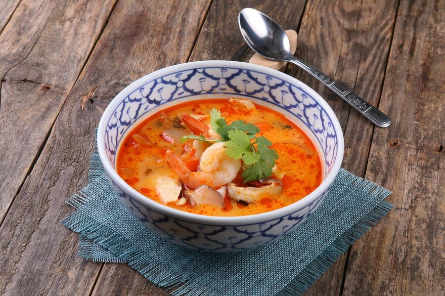 Bowl of authentic Thai Tom Yum soup with shrimp and herbs