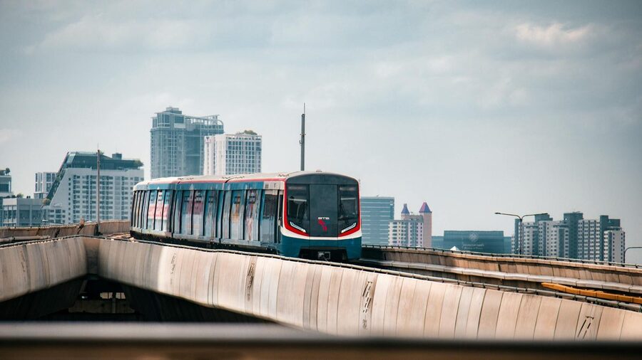 BTS Skytrain passing through urban Bangkok streets