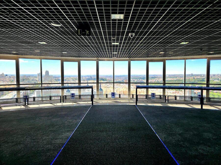 Inside an observation deck with panoramic city views