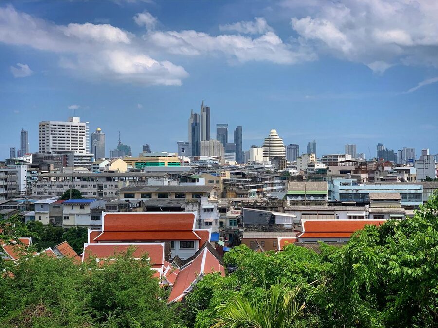 Bangkok skyline with traditional rooftops in foreground