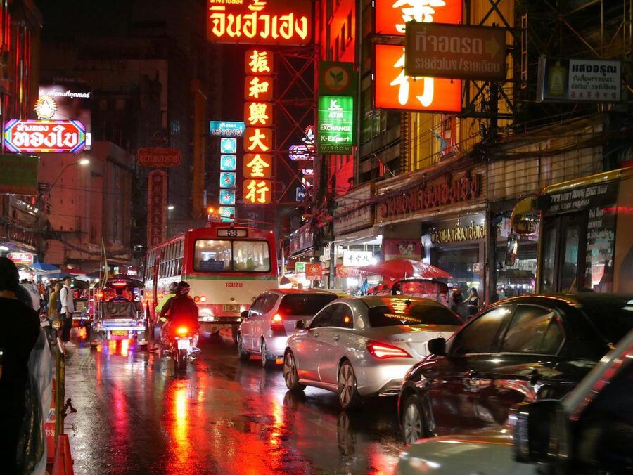 Cars and neon signs in Bangkok Chinatown at night