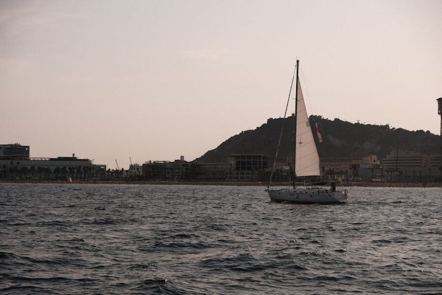 Sailboat sunset Barcelona Montjuic skyline