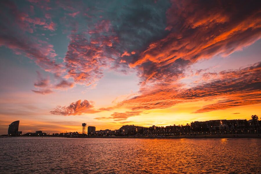 Barcelona sunset over beach with skyline