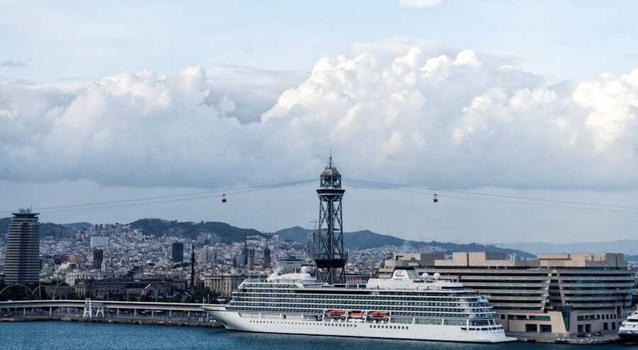 Cruise ship at Barcelona harbour with city skyline