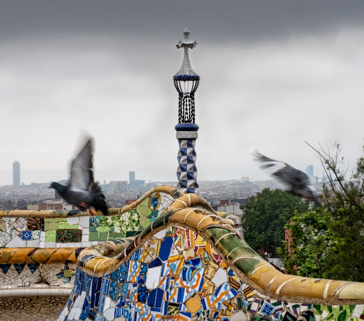 Pigeons flying over Park Güell mosaic