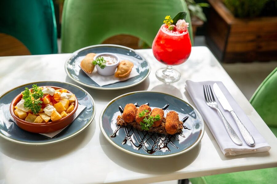 Spanish tapas spread with a cocktail in Barcelona