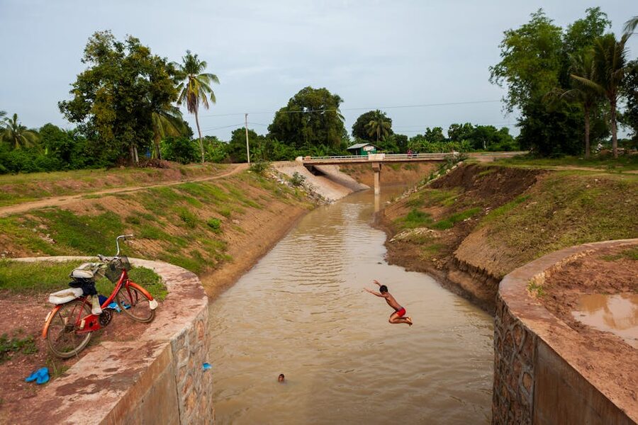 Child diving into a canal in Battambang Cambodia