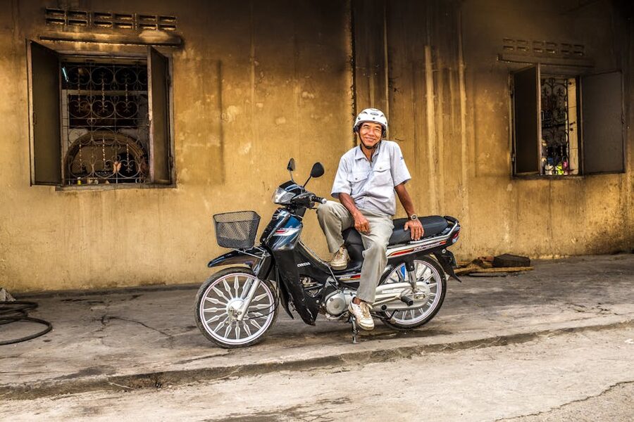 Smiling local man on a motorbike in Battambang Cambodia