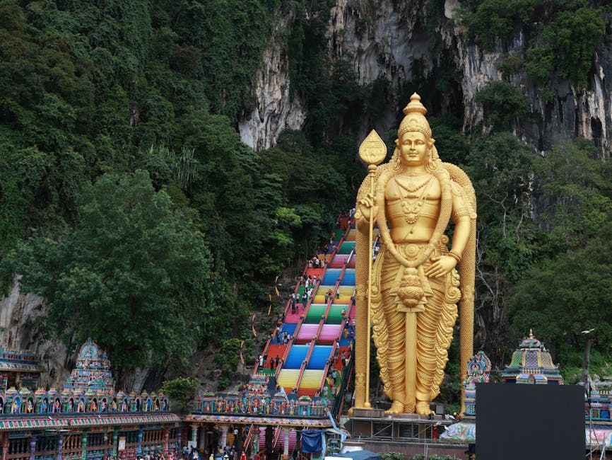 The rainbow painted steps of Batu Caves with the Murugan statue in the background