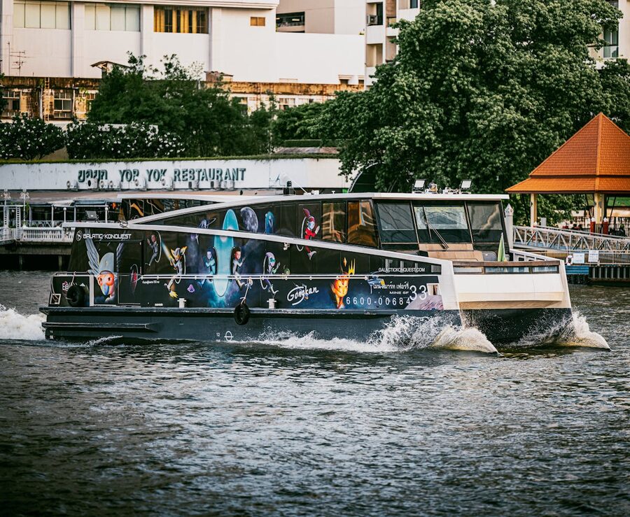 Colorful decorated boat cruising on the Chao Phraya River in Bangkok