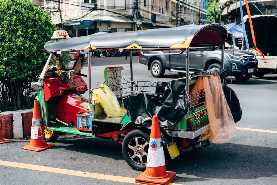 A tuk tuk driving through a Bangkok street