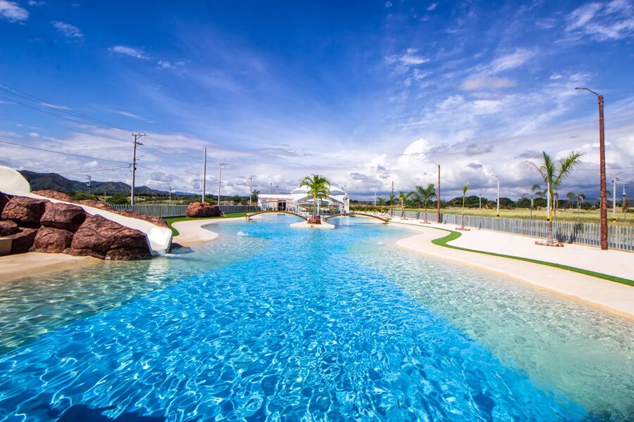 Swimming pool with blue water and slides under bright sky