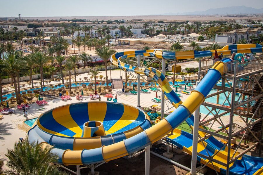 Water park with yellow and blue water slides under the sun