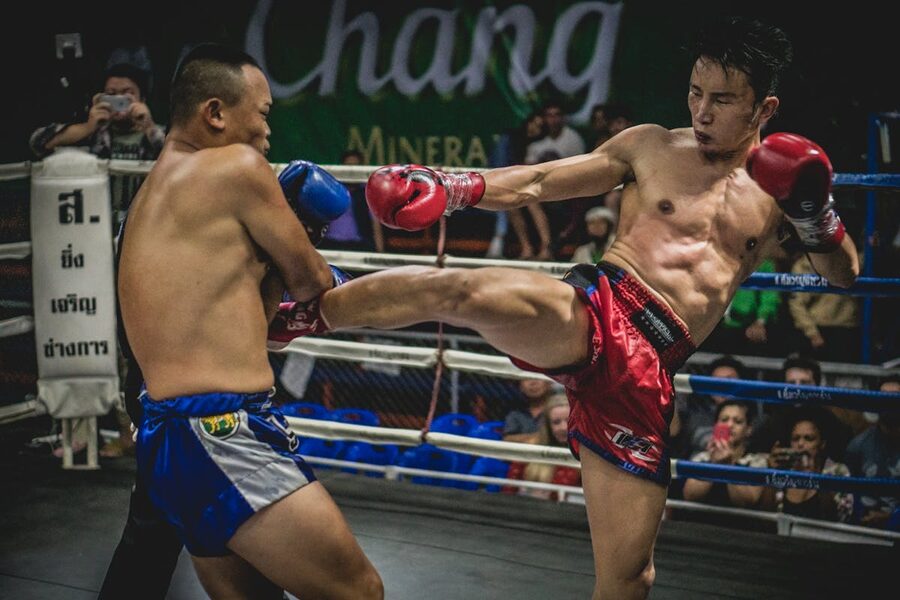 Dynamic moment in a Muay Thai match with powerful kick during competition
