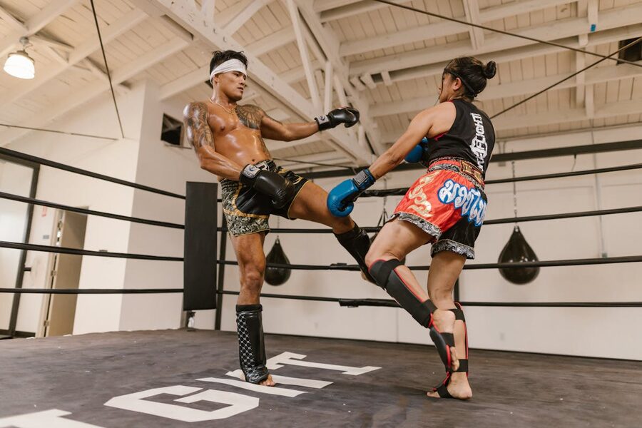 Two fighters sparring in a boxing gym