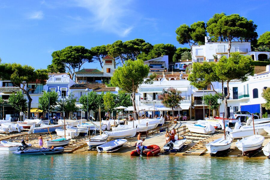 Llafranc cove on Costa Brava with sailboat in clear water