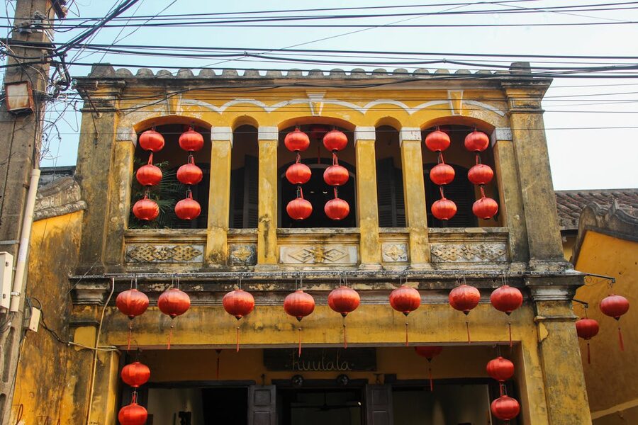Historic yellow building with red lanterns in Hoi An old town Vietnam
