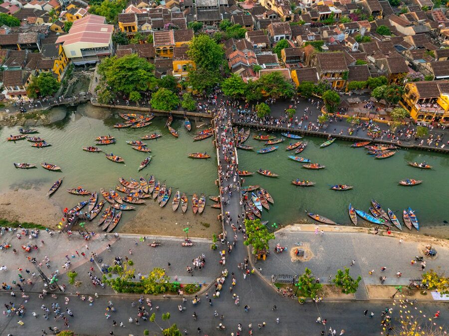 Aerial scene of Hoi An waterfront with boats and night market Vietnam