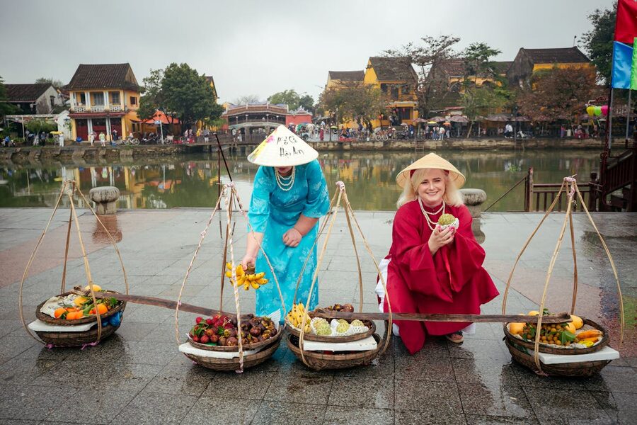 Women selling fruit at the morning market in Hoi An Vietnam