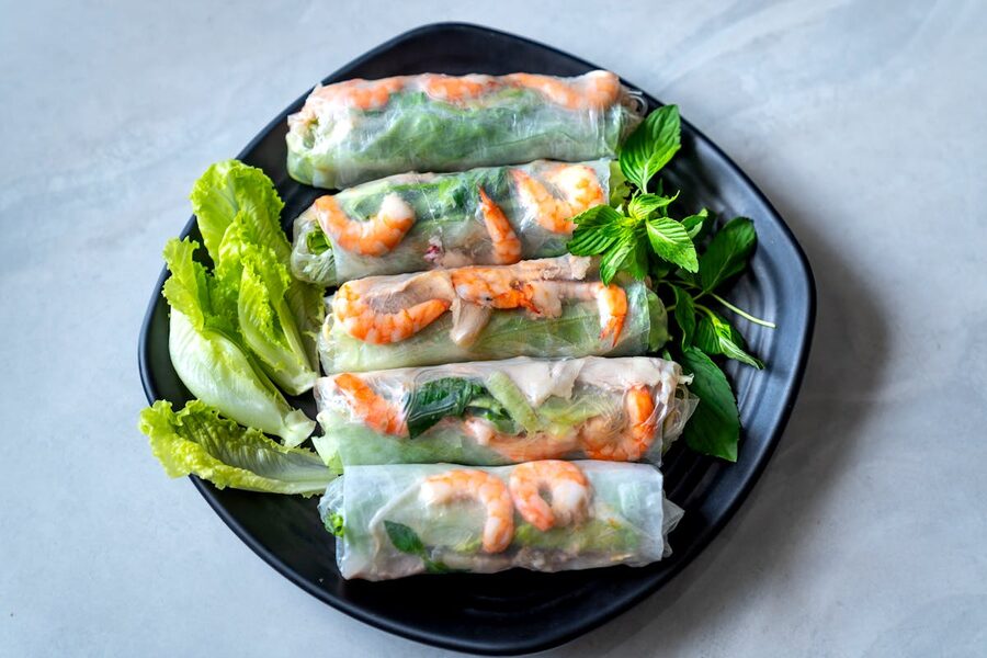 Authentic Vietnamese spring rolls filled with shrimp and vegetables on a plate