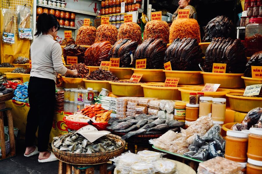 Market stall displaying diverse dried goods and spices in Vietnam