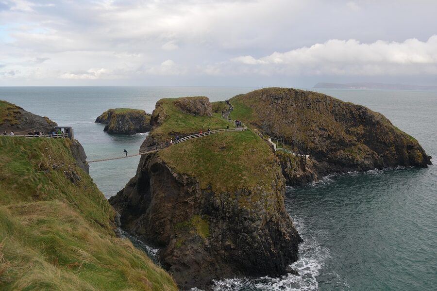 A traveller crossing the Carrick-a-Rede rope bridge to Carrick Island