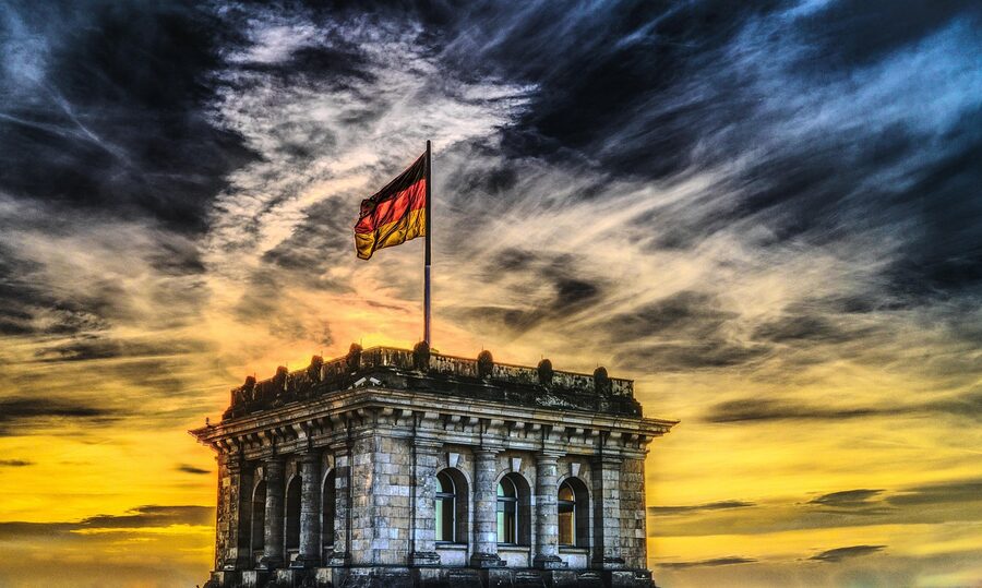 Bundestag Reichstag with German flag and clouds