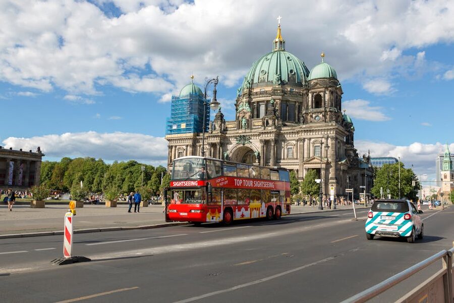 Berlin tour bus passing in front of Berlin Cathedral on a sunny day