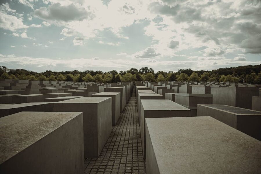 Holocaust Memorial Berlin stelae field under cloudy sky