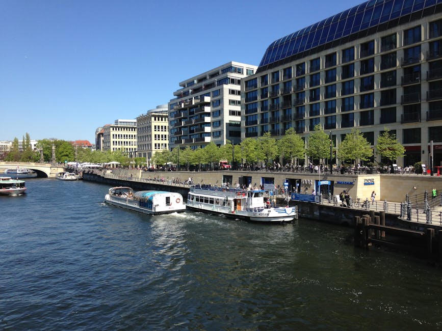 Spree River boats with modern Berlin riverside buildings