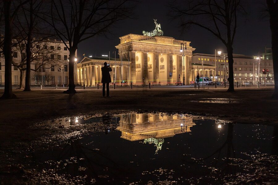 Brandenburg Gate Berlin at night reflected in puddle