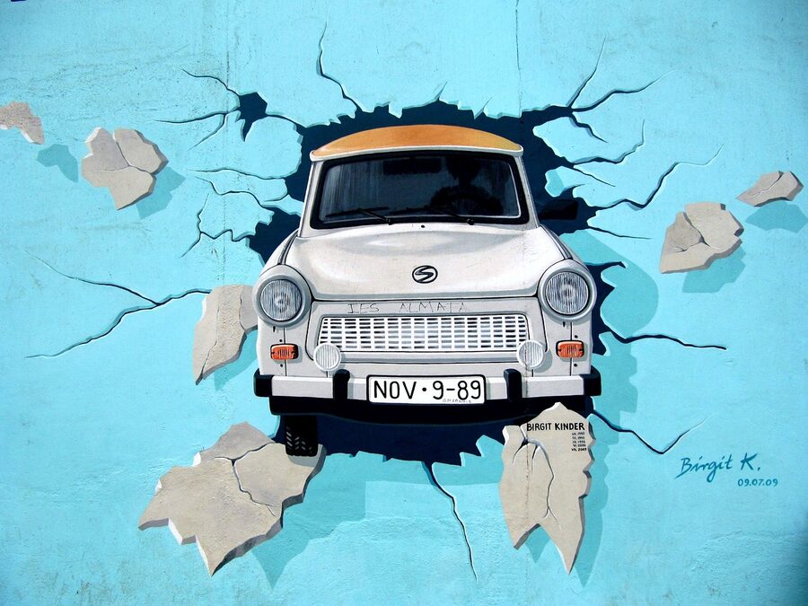 Berlin Wall Trabi car bursting through mural at East Side Gallery