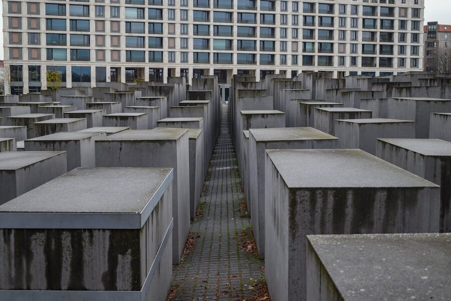 Visitor walking between concrete blocks at Holocaust Memorial Berlin
