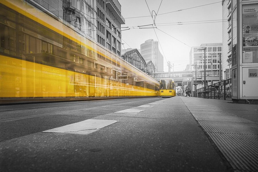 Yellow tram crossing Friedrichstrasse in Berlin at dusk