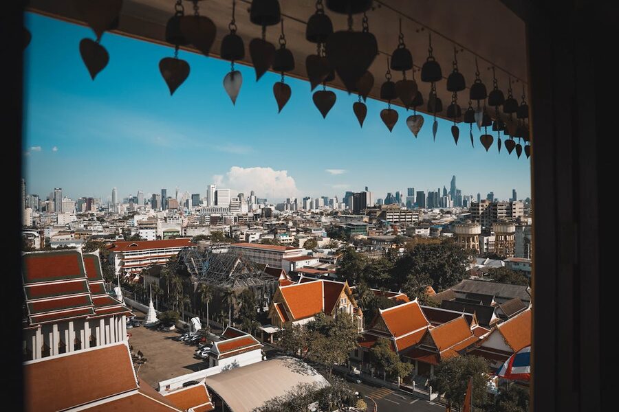 Bangkok city skyline with traditional Thai temples in the foreground