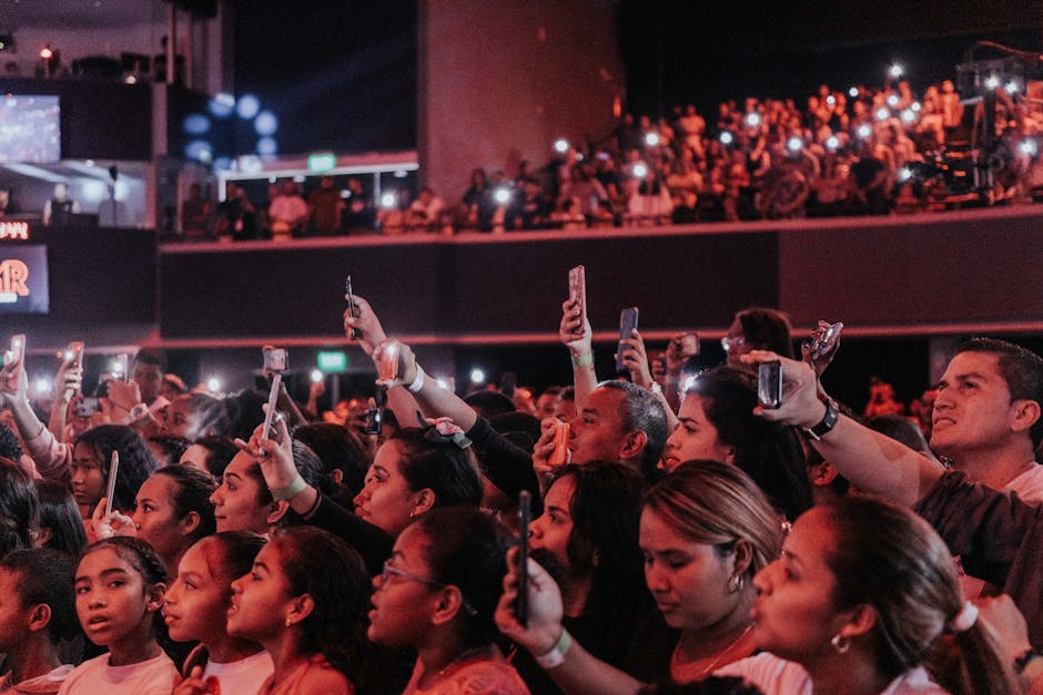 ARMY fans at a K-pop concert waving light sticks