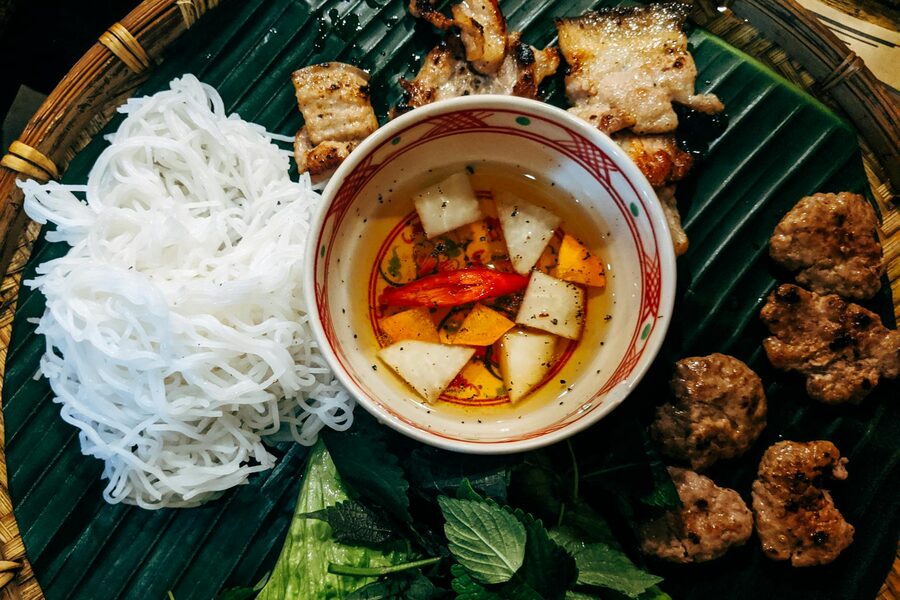 Bun cha served with grilled pork, noodles, and fresh herbs