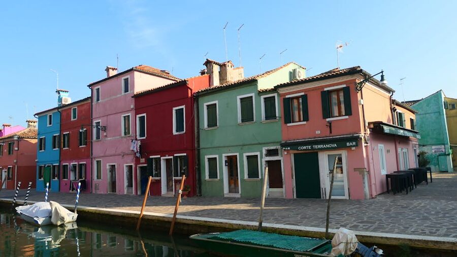 Colorful houses lining a canal on Burano island in the Venetian lagoon