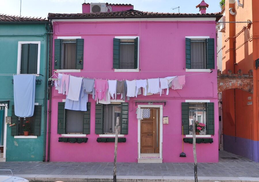 Close-up of Burano colorful house facade with laundry hanging