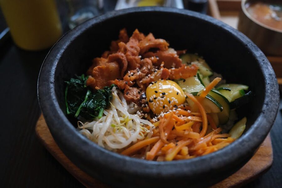 Bibimbap served in a hot stone bowl with fresh ingredients