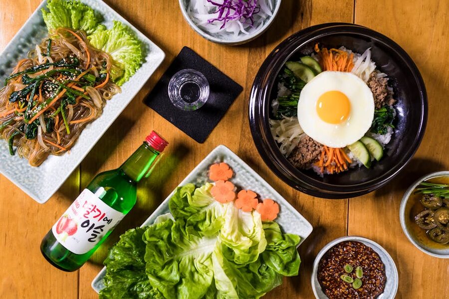 Top view of Korean dishes including bibimbap and japchae